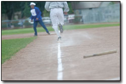 After hitting the ball into center field, a player sprints to
first base. Another vintage rule in place Saturday was that players
could not overrun first base.