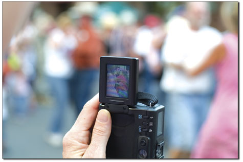A woman captures the street dance on her digital camera, as
hundreds turn out to boggie on Main.