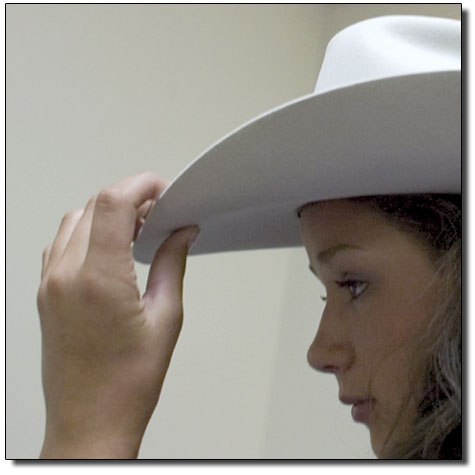 Casey Luzar makes an adjustment to her hat before going on
stage.
