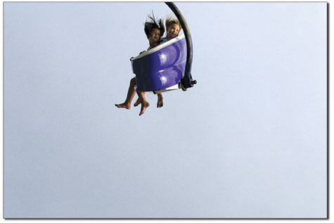 Two girls zip through the air on the Parasail at the La Plata  County Fairs carnival last weekend.