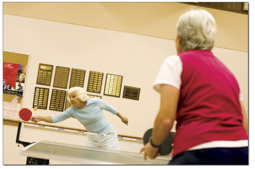 Maryann Crist reaches for another forehand while playing ping
pong with a friend.