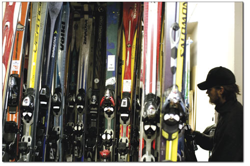 Kelly Hill hangs up a pair of rental skis. Over the past few
weeks, more than 1,500 pairs of skis have been tuned in preparation
of the coming ski season.