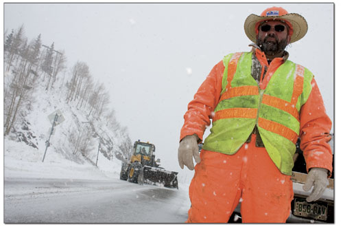 CDOTs Ray Kessler stands on Highway 550 while a front-end-loader
removes snow from the road.