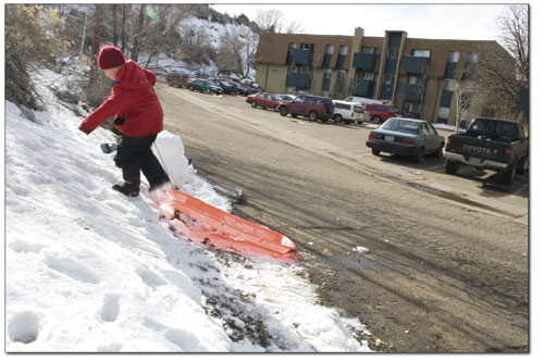 Daniel Ashenfelter drags his sled up a small sledding hill above
the Mountain Sun apartments parking lot on Florida Road
recently.
