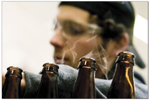 Chase Engel oversees the bottling process for some
larger-than-average bottles of the new all-organic beer.