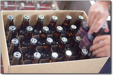 Jason Bergman drops the last three bottles into a case, which is
then sealed and shipped, ready for drinking enjoyment.