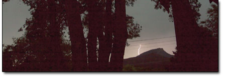 Lightning strikes behind Perins Peak on Monday afternoon, as
seen from the deck of an in-town home.