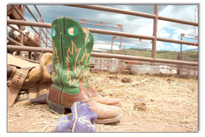 A tired pair of boots rests by the gates after a weekend full of
rodeo.
