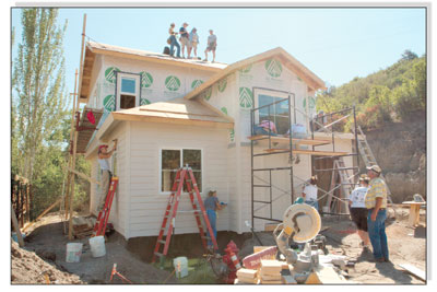 The women get working on Saturday morning on various projects
from siding to roofing and trim work.