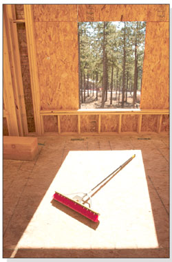 A push broom is poised perfectly on the subflooring of a house
under construction at Edgemont Ranch.