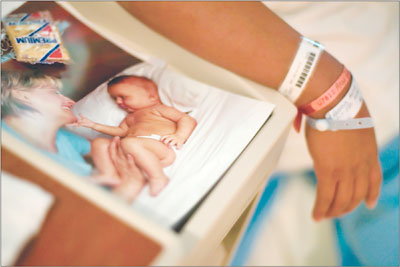 aA mix of bracelets adorn the wrist of Anna Garcia, next to a
pamphlet for new mothers.