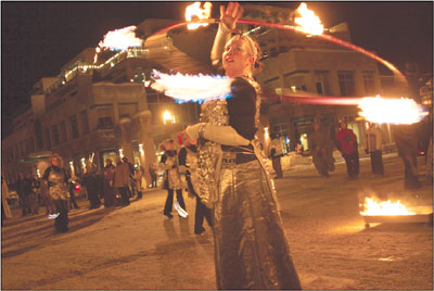 A performer with Beau Jos Mountain Bistros fire dancers gets a
few more spins before wrapping up the parade on 12th Street.