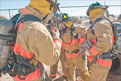 Fellow trainees help each other out after a long, tight crawl
with full gear.
