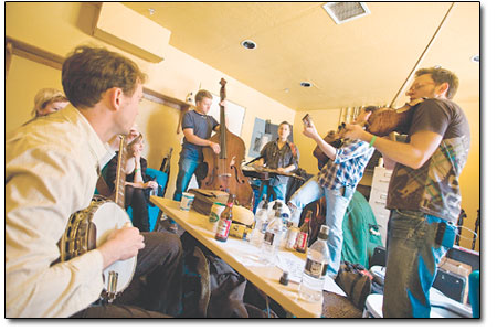 The Infamous Stringdusters have a bit of warm up in the green
room just before playing to a capacity crowd at the Durango Arts
Center on Saturday.