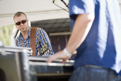 JJ Grey watches as Adam Scone lays it down on the keys during
the Mofro set on Sunday afternoon.