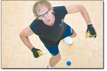 David Farmer, owner of the Durango Sports Club and a participant
in last weekends competition, stays focused as the ball bounces by
him and off of the back wall. Players have four walls with which to
play off of.