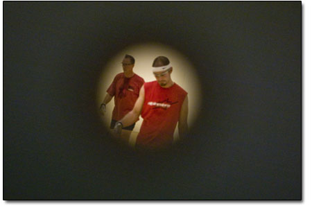 Tony Rocco, right, and his teammate are seen through a peephole
in the door during a doubles match. Tony was the director of the
tournament.