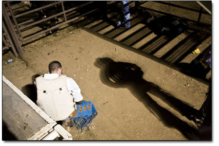 A rider prays before hopping into the chute.