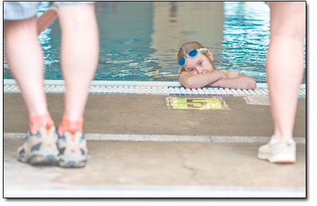 Andie Miller, 9, looks pasues for reflection as she waits in the
pool for her age division to begin racing.