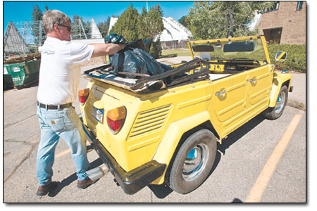 Paul Reeves decides not to wait for the city pick up and loads
his findings into the back of his VW Thing on Saturday.