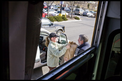 John Gamble, of the VOA, graciously receives a bag of food from
a drive-by donator. In addition to eatables, the United Way also
accepted monetary donations, including a $5,000 check from Alpine
Bank.