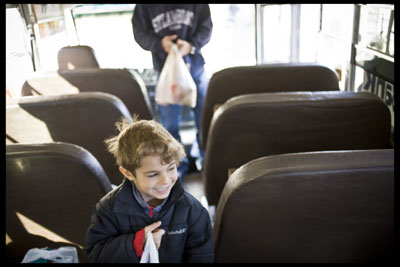 Irie Sentner and his father, Lee, make a donation aboard the bus
on Saturday.
