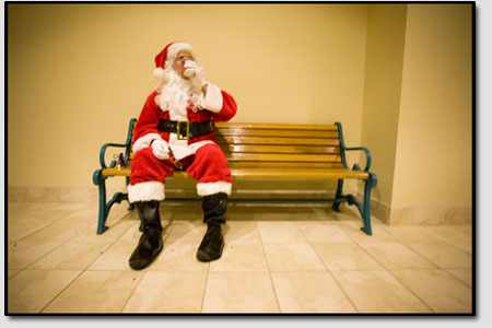 In a well-deserved moment of relaxation, Claus sits back and
takes a load off during his 15-minute break. Its not easy being
Santa.