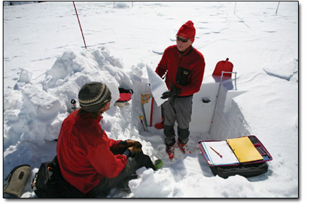 Chris Landry, with help from Andrew Temple, conducts a detailed
examination of a snow profile.