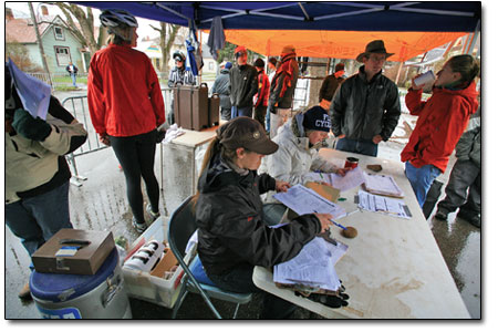 Volunteers sort through registration forms at the racer
registration station on 4th Ave. on Saturday.