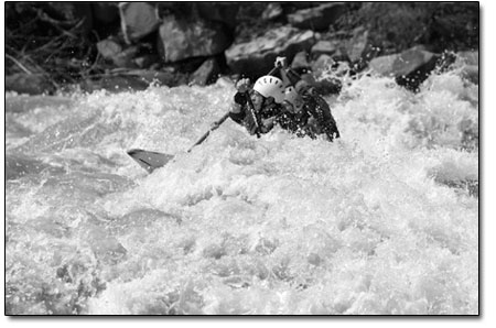 Mens C2 competitors dice through the waves during a practice run
below Smelter Rapid.