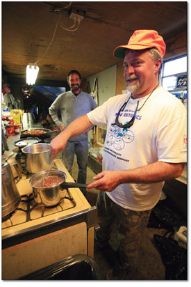 Man of the kitchen, Richie Richmond, stirs a pot of Anasazi
beans.