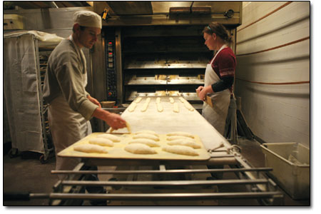 Mark Davis and Chala Sterling load up the oven racks.