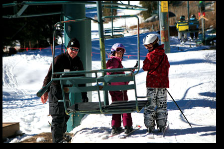 Lift op Dave Dowrick helps a couple of youngsters safely load
Chair 4.
