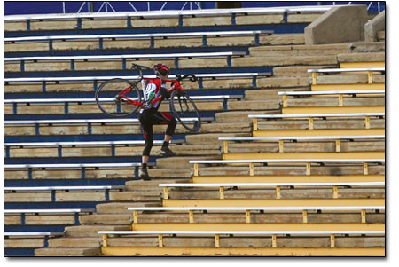 A rider charges up the stadium stairs.
