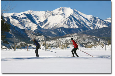 A pair of skiers enjoy the classic view from Hillcrest.