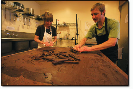 Once the chocolate has reached tempered perfection, it is shaved
from the table and ready for use.