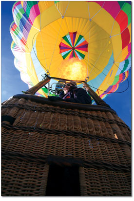 Pilot Karl Peterson, of Salt Lake City, lets one rip into his
balloon before lift off.
