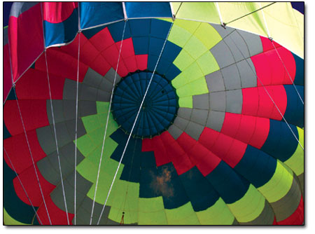 Light filters through the patchwork of a deflating hot air
balloon after the ascension.