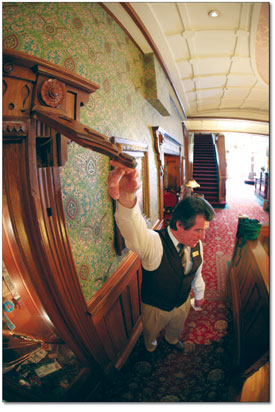 Bellman and tour guide, Charles Thames, reveals one of the famed
secret compartments. Used to stash valuables in the days of the
Wild West, they are now mostly a tourist attraction.