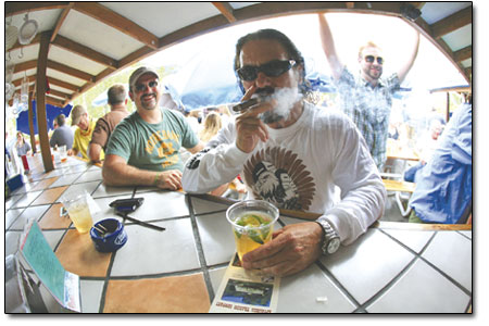 Mike The Hammer Greene enjoys a fine cigar at The Balcony Bar,
formerly El Patio, on College and Main.