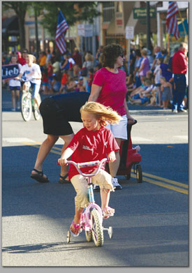 A young rider checks out her own shadow along the parade
route.