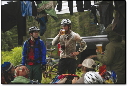 Trail sweepersand on site bike mechanics Eric Confer, left, and
Jon Bailey, arrive at camp thirsty and wet, after hunkering down in
the trees during the afternoon squalls.