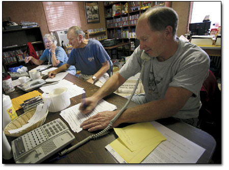 Jim Mackay, front, along with Brian and Kitty Benzar get busy
taking membership pledges from faithful listeners across the Four
Corners area.