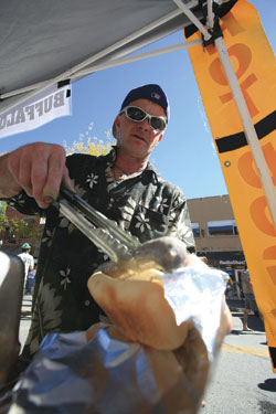 Terry Zink serves up footlong German-style brats to a ravenous
crowd.