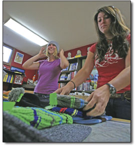 Laura Sainio, left, of Backcountry Experience, tries on some new
gear while Breanna Powers arranges a display.