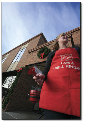 Salvation Army bell ringer Nicole Blake enjoys the unseasonably
warm bell-ringing conditions.