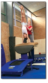 Stephanie Walker gives a spot to Jordan Eler while training on the vault