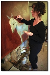 Painter Phyllis Stapler focuses in on a recent work in progress.